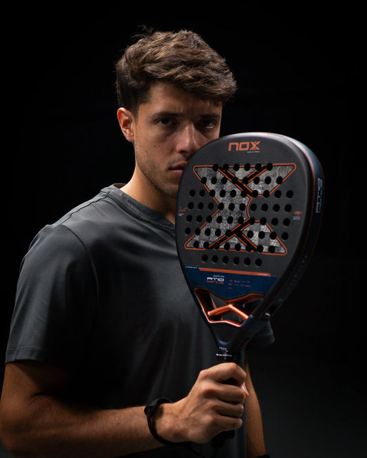 Augustin Tapia holding the NOX AT10 18K Tapia padel racket
